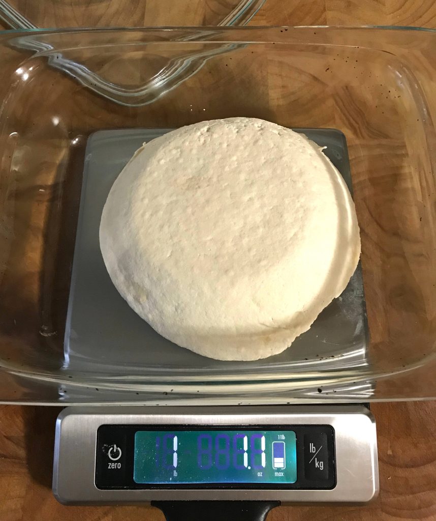 one pound of homemade tofu on a scale
