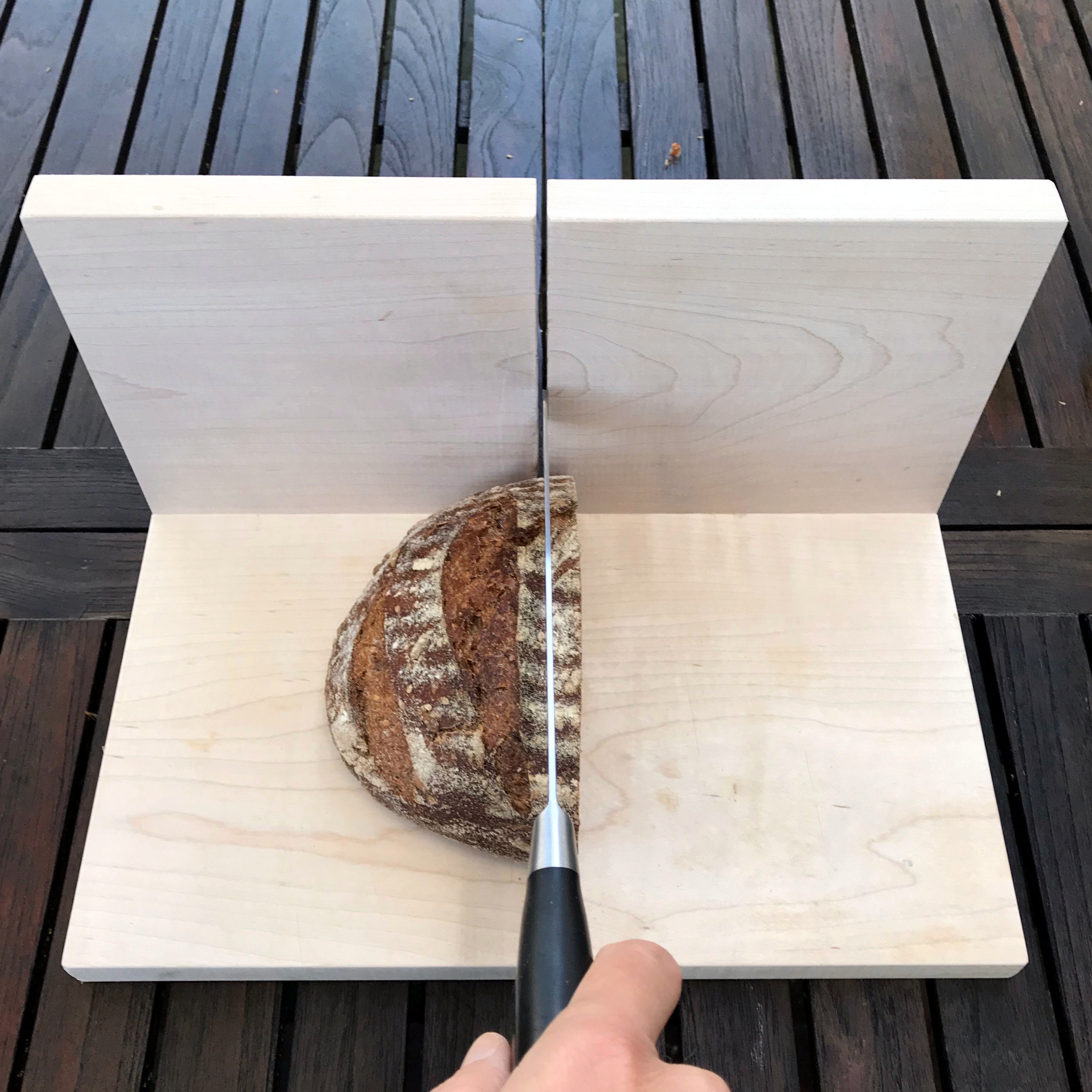 bread slicing guide with a loaf of sourdough bread