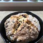 a loaf of Irish soda bread cooking in the cast-iron pan it was baked in