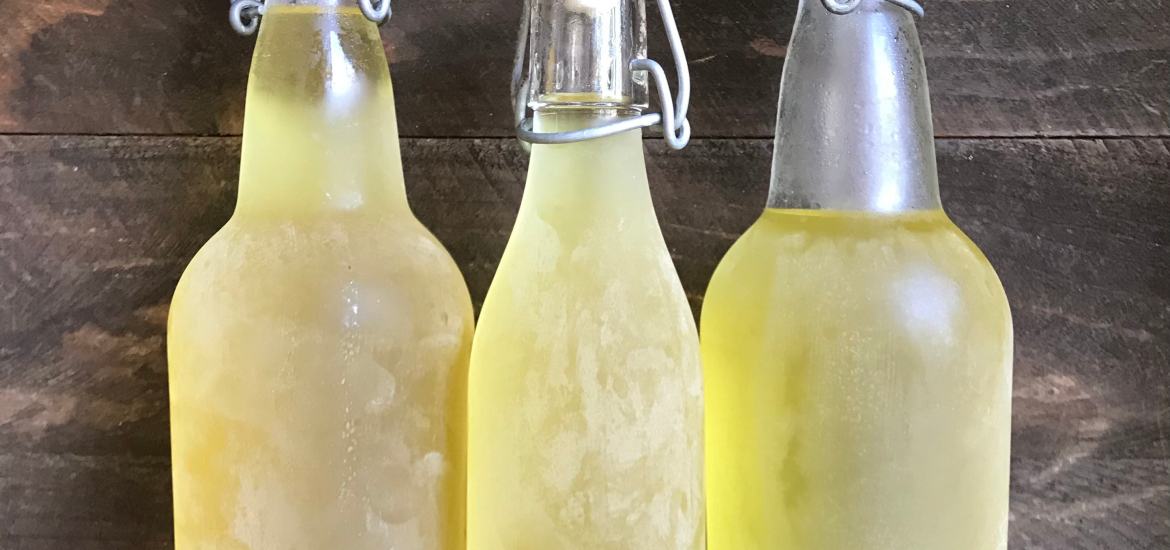 three bottles of limoncello made out of lemon peels to use up all the food scraps