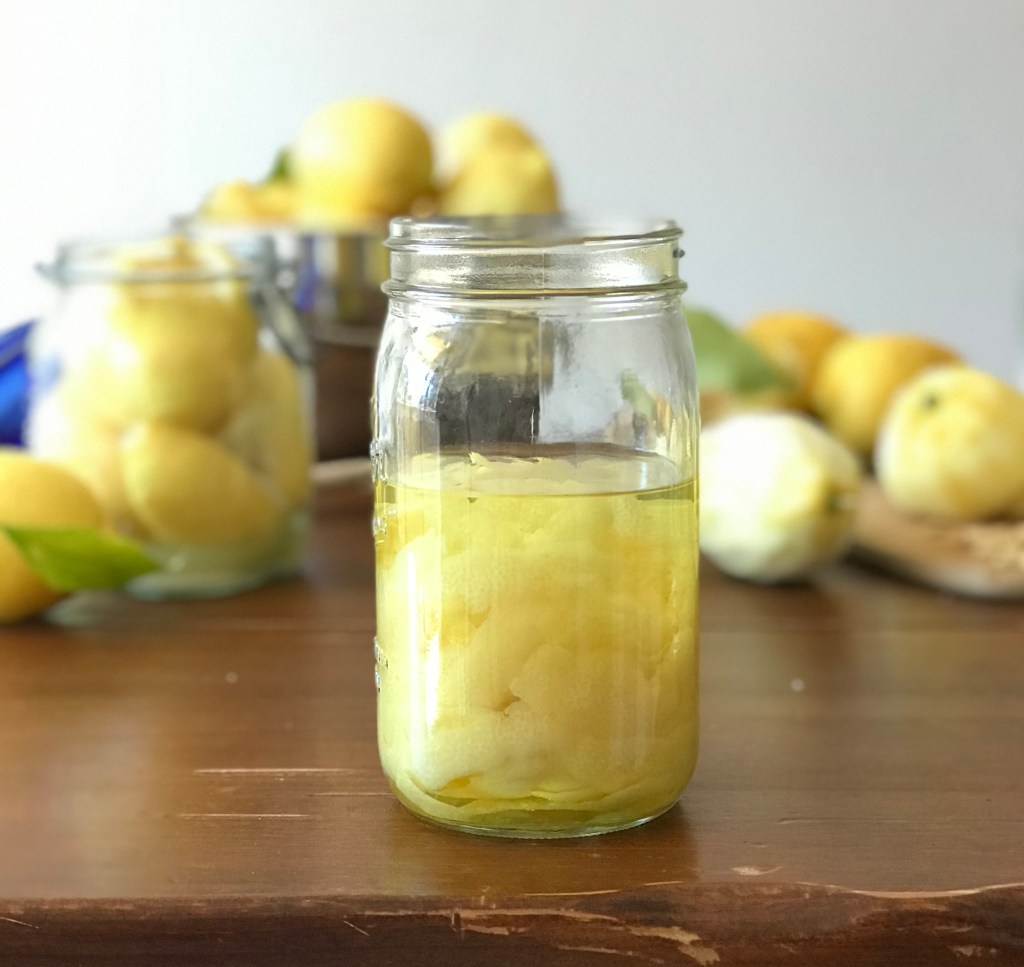 lemon peels steeping in vodka to make limoncello