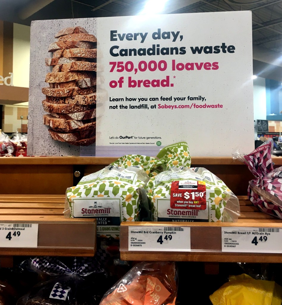 A sign in Sobeys in the bread section to help raise awareness of food waste. The sign says that 750,000 loaves of bread go to waste every day in Canada.