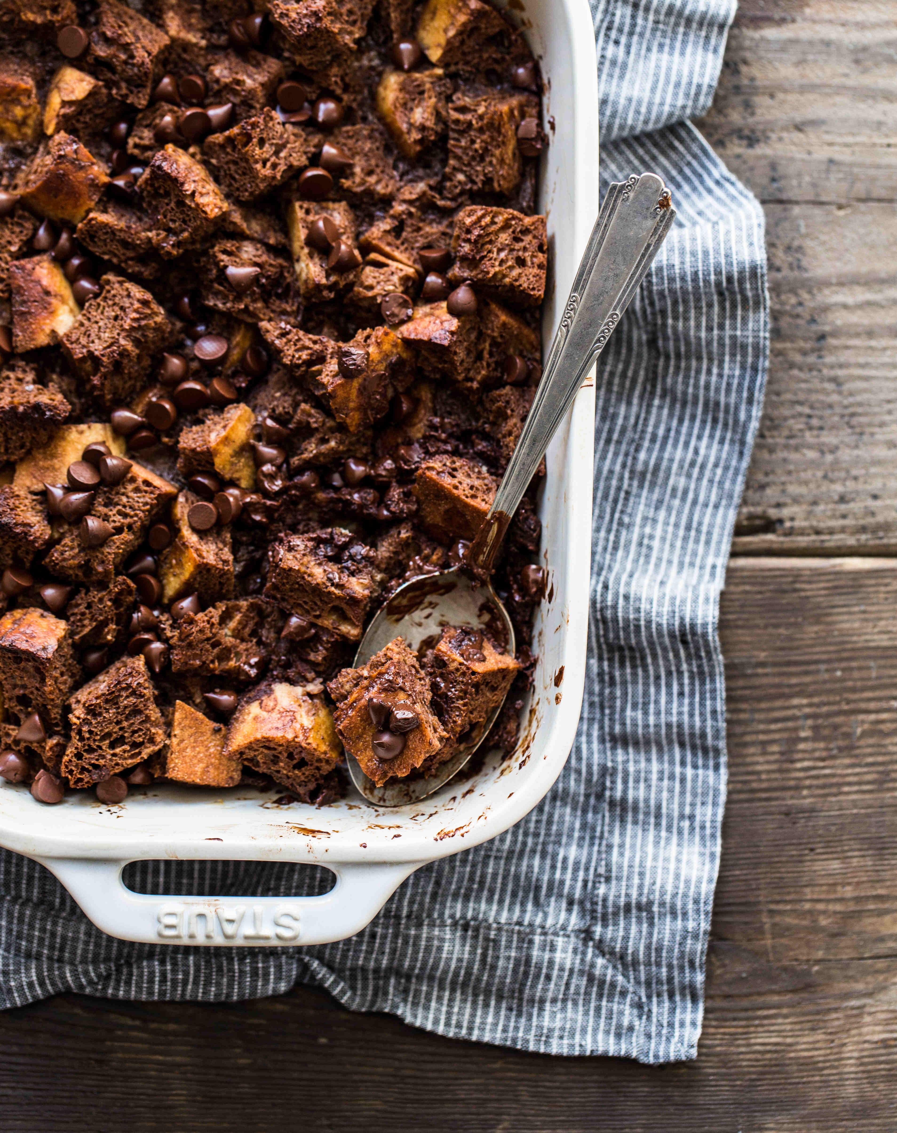 A rectangular white baking dish containing chocolate bread pudding to reduce wasted food