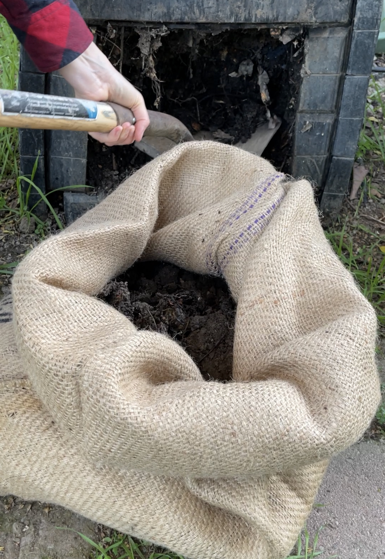 filling the burlap sack planter with soil and compost