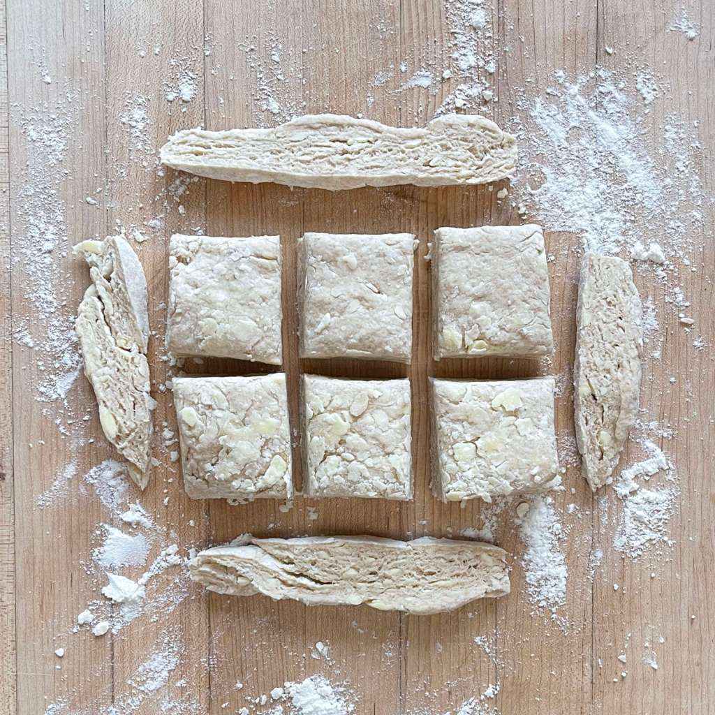 Sourdough biscuit dough cut into squares and edges