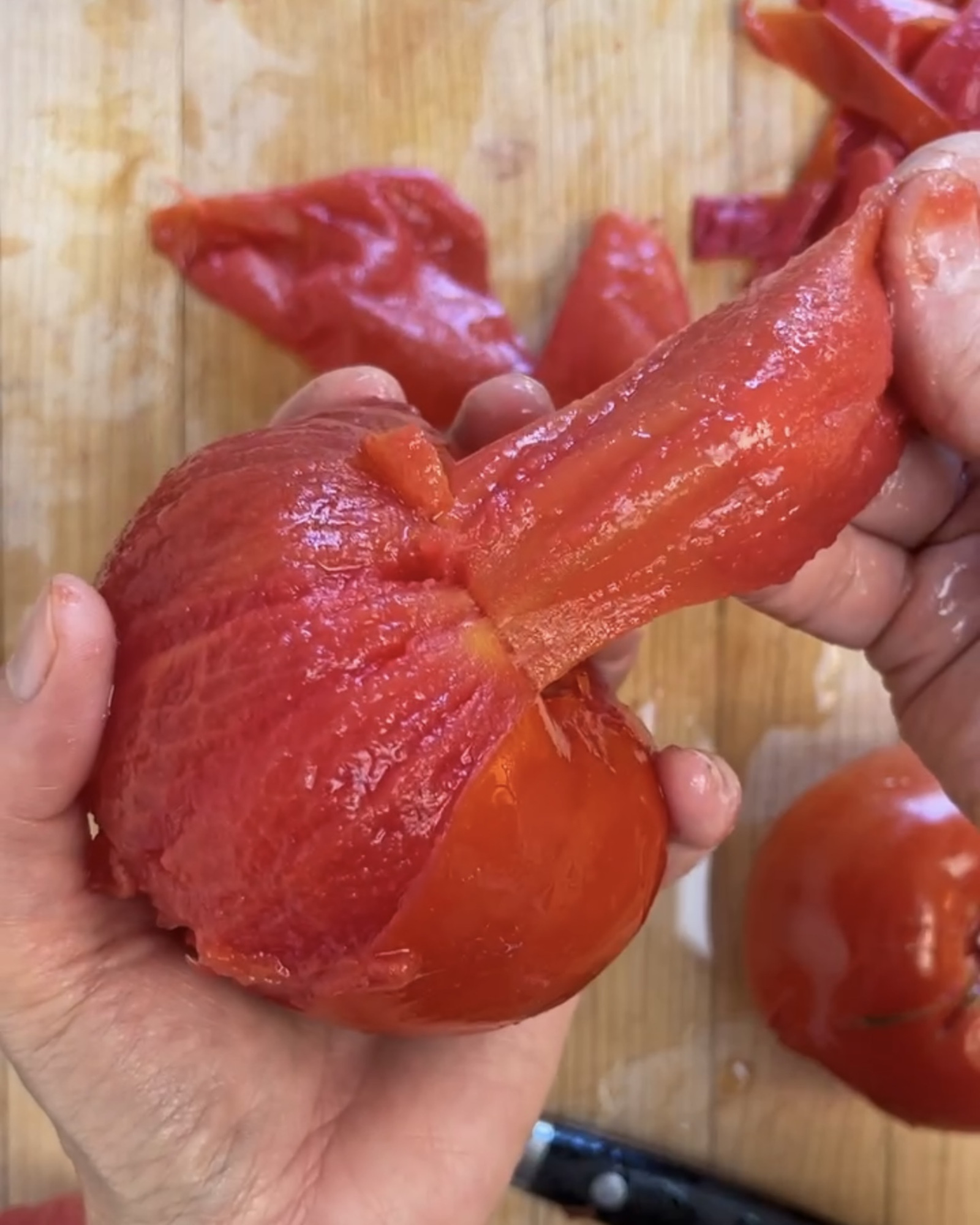 Fingers easily pull the skin off of a blanched tomato