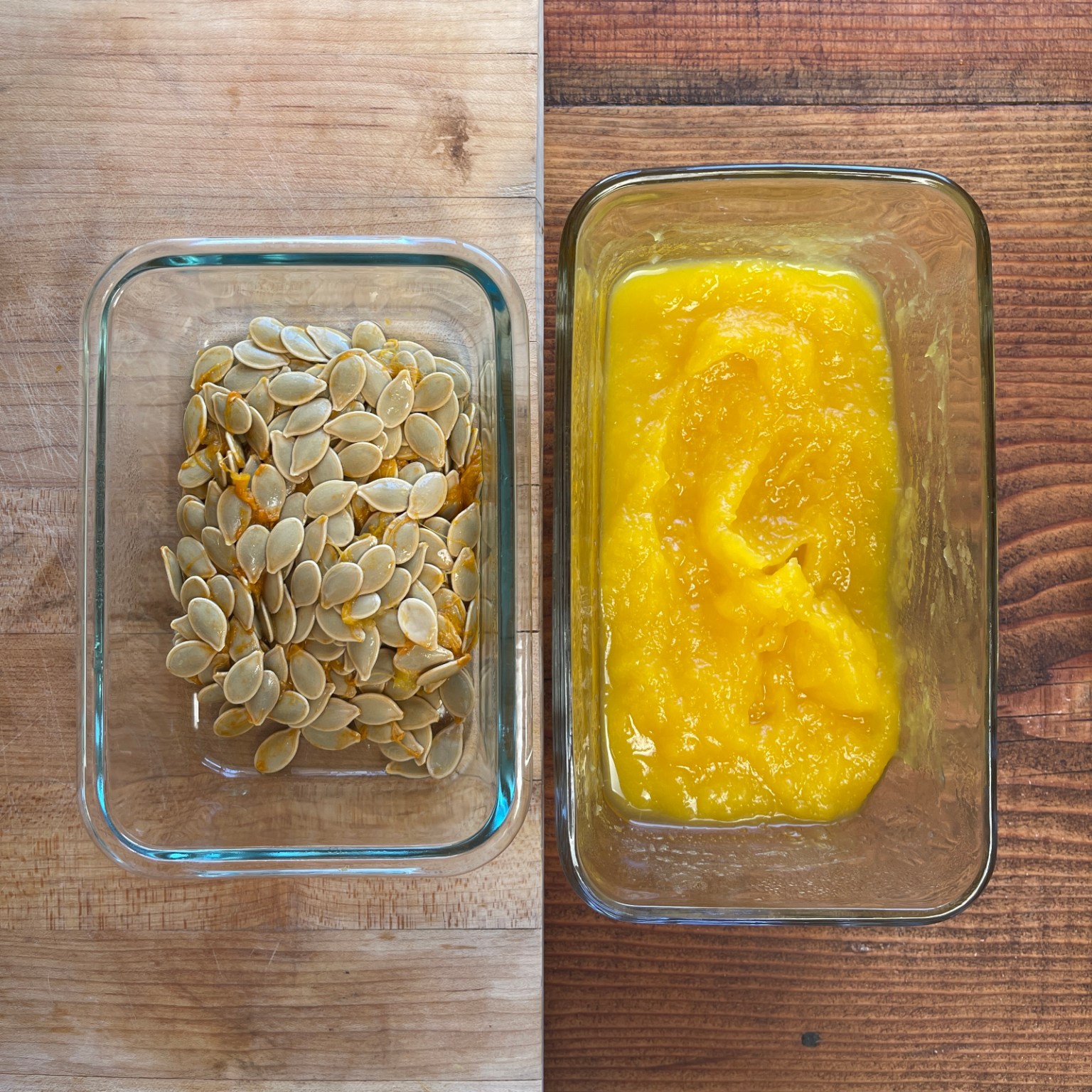 A glass dish of raw pumpkin seeds sits to the left of a glass dish of pumpkin purée