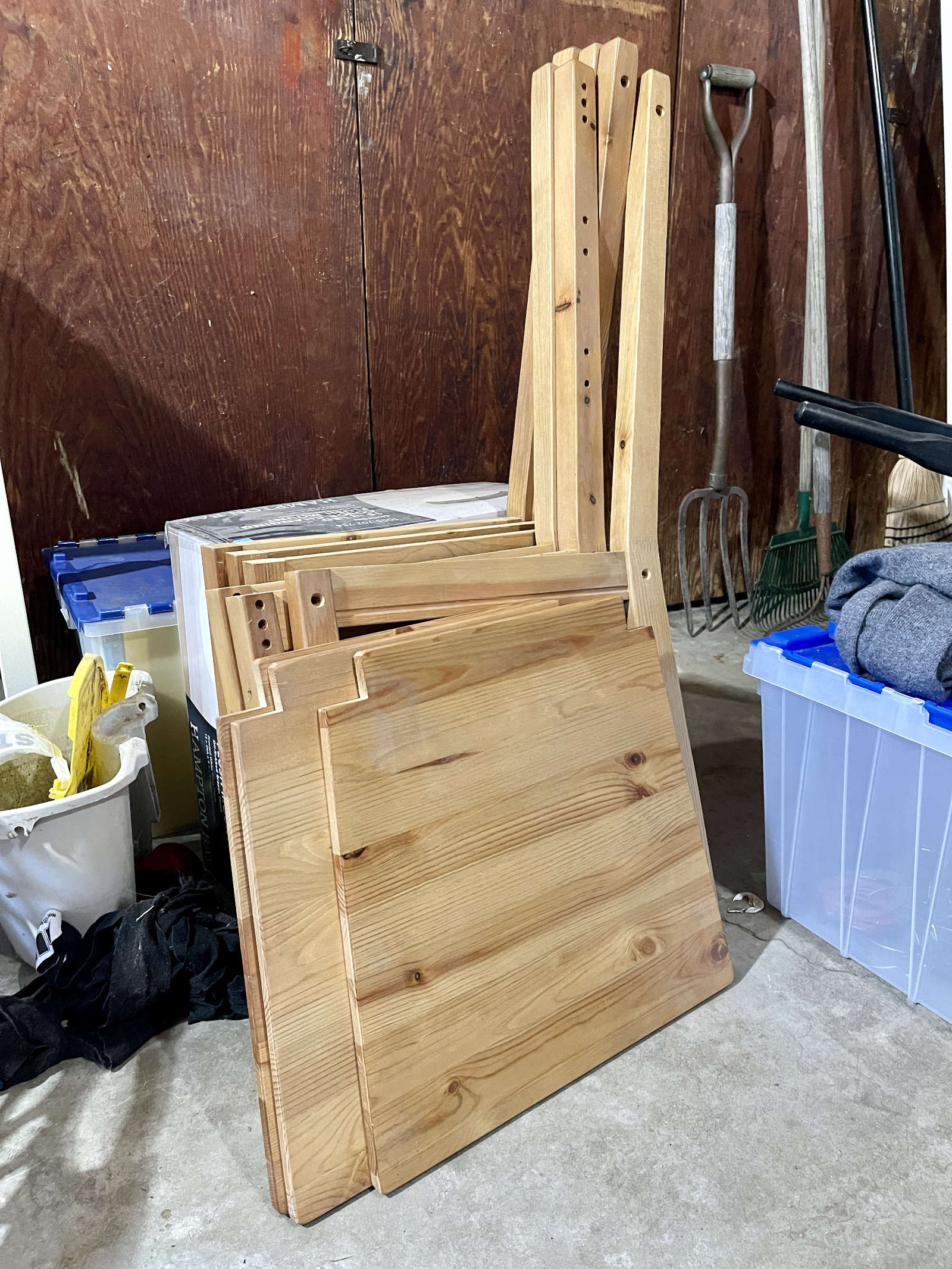 Three unassembled IKEA chairs in a garage