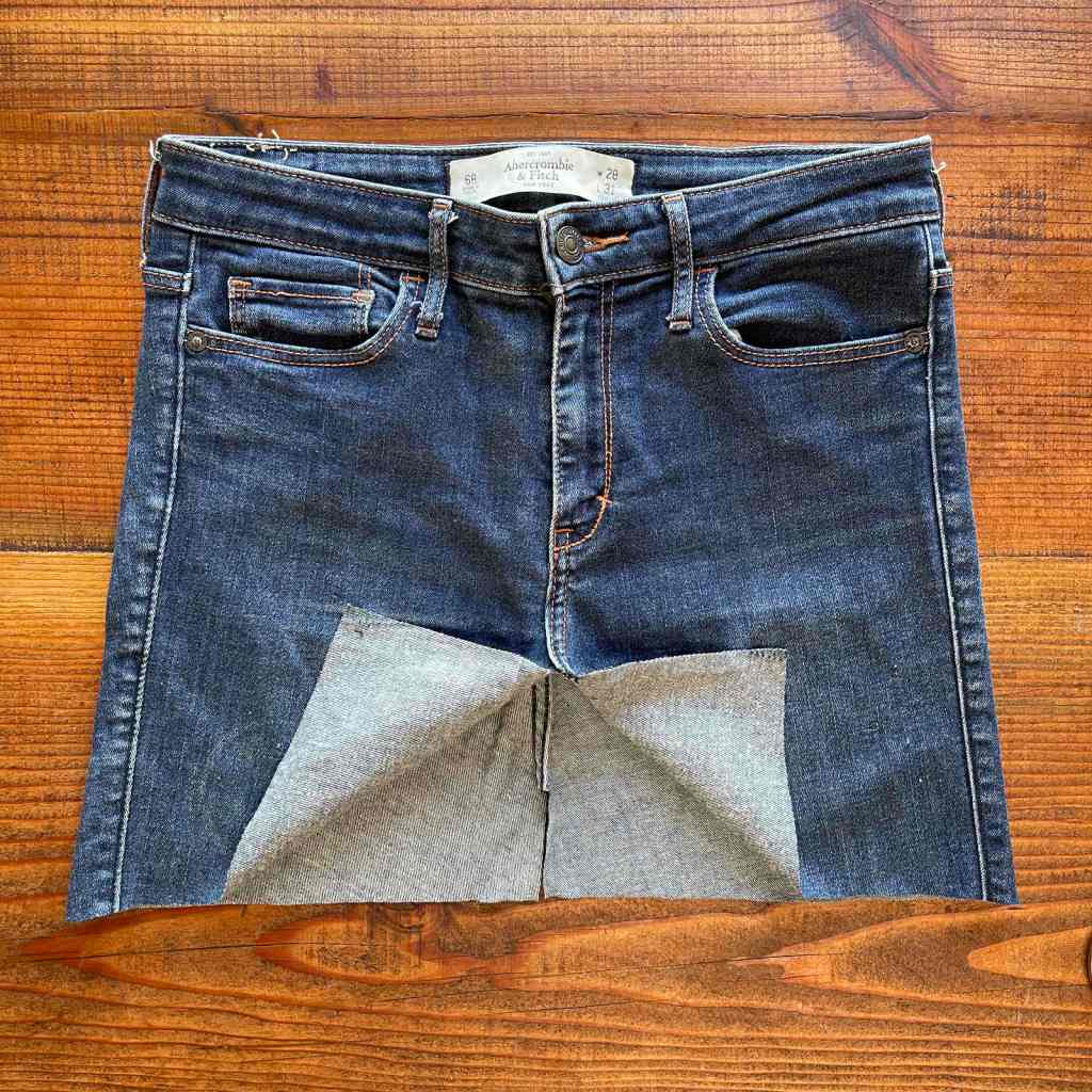 The seat of a pair of cutoff jeans had been made flat before sewing into a denim shopping bag