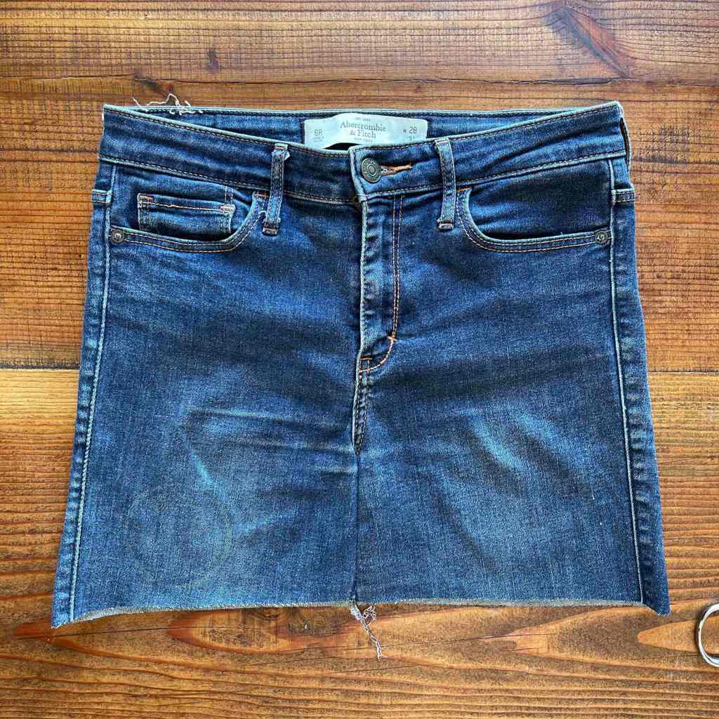 The front panels of cutoff jeans that have been trimmed to make a flat seam have been sewn together