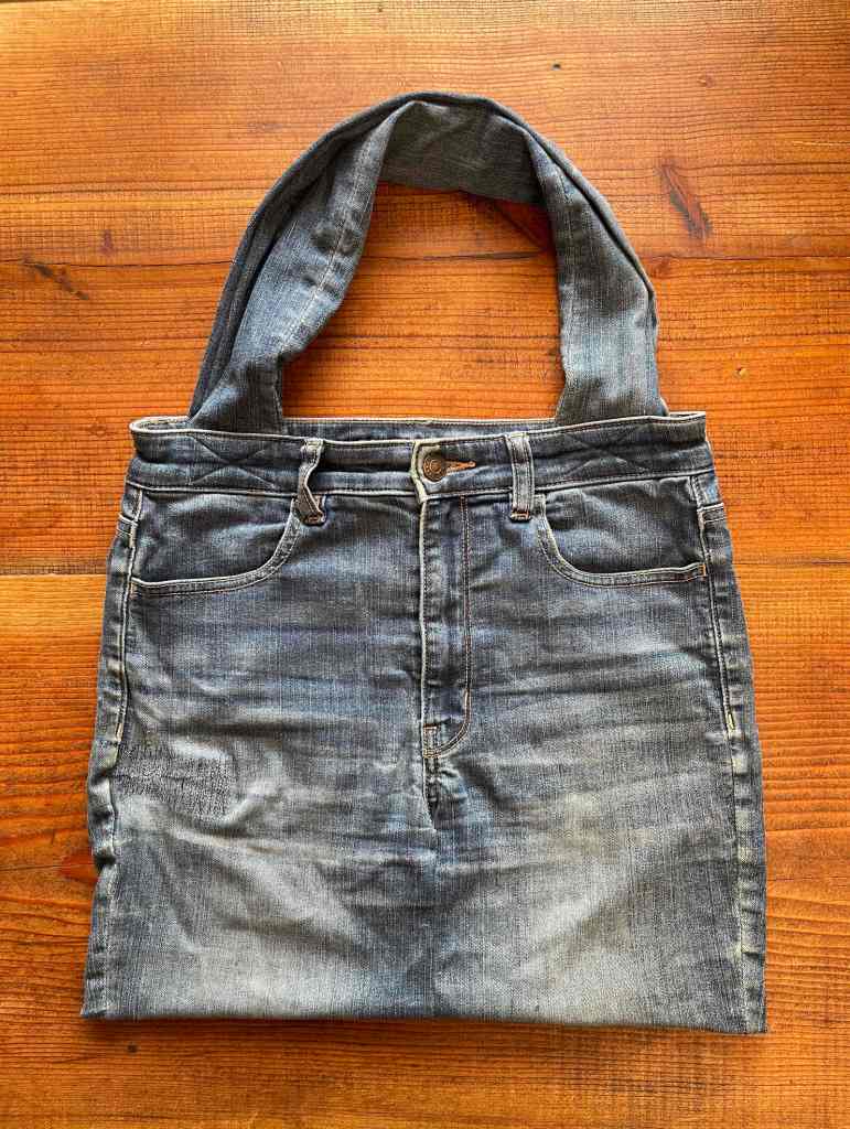 Front view of a denim bag made out of old jeans
